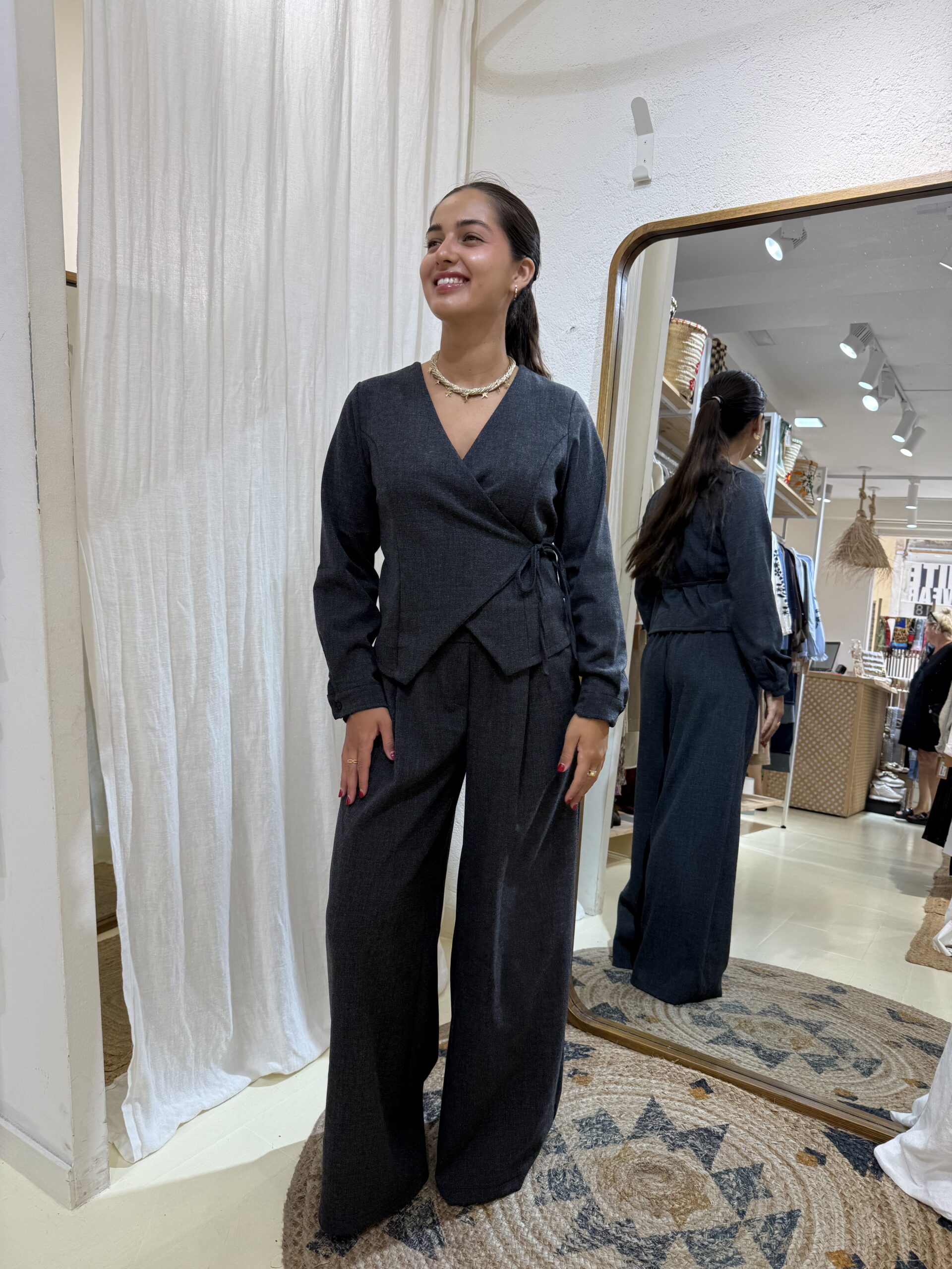 COMPRAR Conjunto de tejido tipo sastre con top cruzado de lazo lateral y pantalón wide leg de tiro alto con pinzas. Disponible en gris antracita y beige.